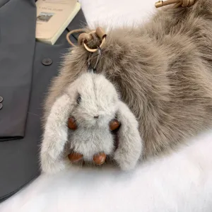 Fluffy plush shoulder bag detail with cute bunny keychain, soft cloud bag texture for women.