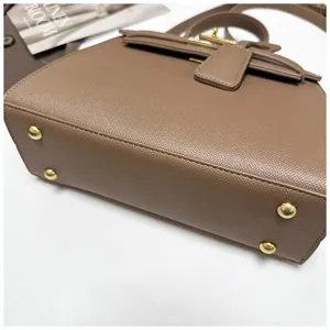 Taupefarbene Damen Kelly Umhängetasche aus Leder mit goldfarbenen Beschlägen und Metallfüßen.