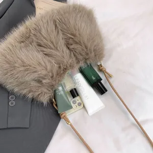 Close-up detail view of stylish faux fur shoulder bag with delicate strap and cosmetic props.