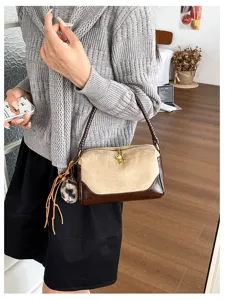 Classic contrast color shoulder bag featuring suede and leather texture, elegant daily commute style.