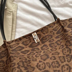 Detailed view of a trendy Korean style leopard print tote bag with metallic twist lock closure.