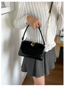 Chic black shoulder bag, stylish suede leather handbag with gold chain and star charm.