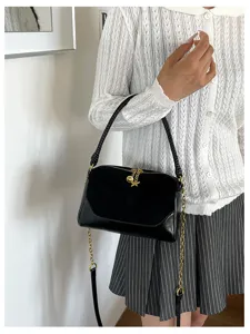 Chic black suede shoulder bag with gold chain strap and cute star charm for women daily commute.