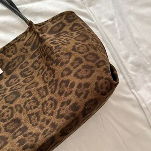 Detailed view of the retro brown leopard print tote bag, showcasing soft suede texture and black straps.
