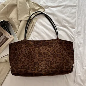 Detailed view of brown leopard print tote bag with black straps, stylish daily commute accessory.