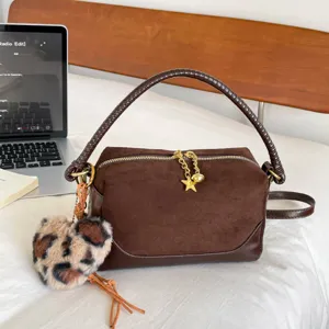 Brown suede pillow shoulder bag with fluffy leopard heart charm, stylish commuter handbag main view.
