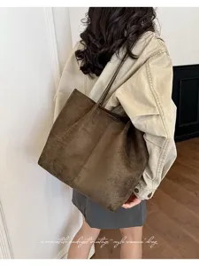 Close-up of brown suede tote bag, vintage style, soft texture, elegant daily commute style.