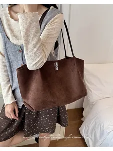 Detail view of the brown suede vintage tote bag, showcasing soft texture and chic style.