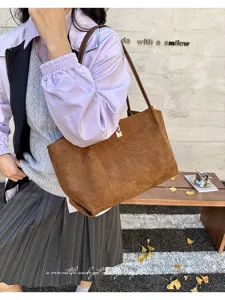 Detailed view of the retro brown suede tote bag, offering large capacity and stylish underarm wear.
