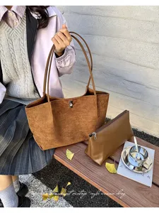 Detailed view of retro brown suede tote bag and matching pouch set with classic design.