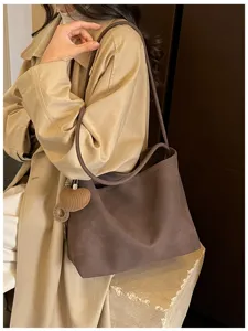 Brown minimalist large capacity shoulder tote bag with cute heart pendant for daily commute.
