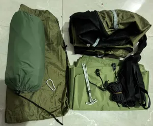 Outdoor camping hammock parts detail view, showing storage bag, stakes, straps and ropes.