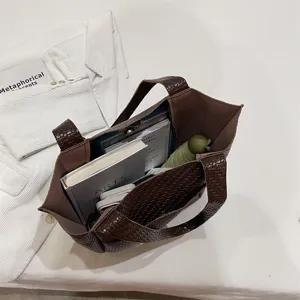 Woven tote bag for women, stylish shoulder handbag with large capacity and elegant design.