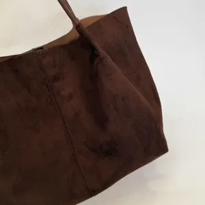 Braune Wildleder Shopper Tasche Detail zeigt Textur, weiches Design und Naht im Nahbereich