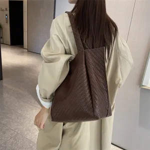 Brown woven tote bag for women, stylish leather shoulder handbag for daily commuting fashion.