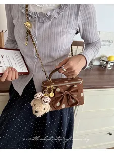 Chic polka dot vanity bag with elegant bow, chain strap and adorable bear charm for women.