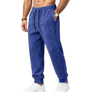 Detailed view of men's blue suede sweatpants, showcasing elastic drawstring waist and cuffed hem.