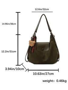 Detailed view of the dark green shoulder bag with clear size measurements and plush bear charm.