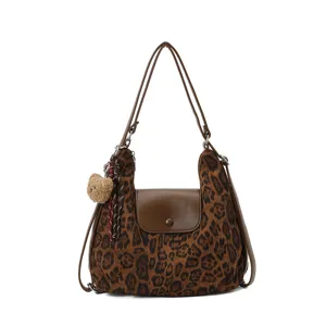 Fashionable leopard print shoulder bag with brown flap and cute bear pendant detail.