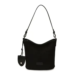 Black suede shoulder bag detail showcasing premium fabric texture and hardware.
