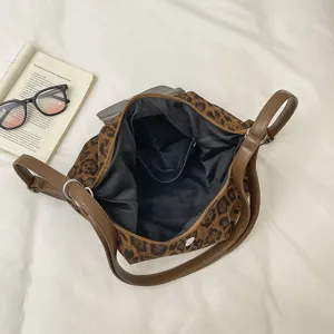 Leopard print shoulder bag interior detail showing spacious compartment and brown leather straps.