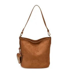 Brown suede shoulder bag, chic bucket bag design with stylish hanging pouch and slim strap.