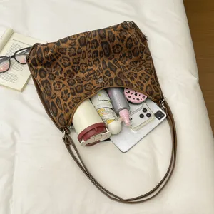 Detailed view of the leopard print shoulder bag showcasing its spacious interior capacity and items.