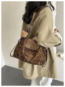 Fashion leopard print shoulder bag with brown flap and cute bear pendant for daily commuting.