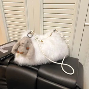 White fluffy plush hobo shoulder bag with cute grey bunny charm for women casual daily use.