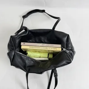 Detail view of spacious black shoulder bag interior showing large storage capacity.