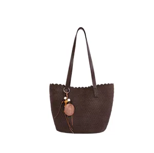 Detailed view of the elegant dark brown woven texture shoulder bag with a stylish pendant.