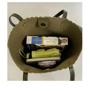 Olive green suede tote bag detail, stylish woven button closure, large capacity daily use.