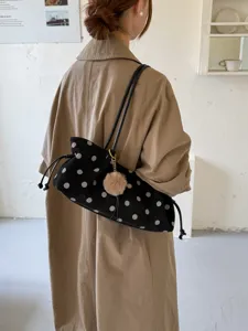 Black polka dot shoulder bag with cute plush pom-pom pendant, casual minimalist tote bag.