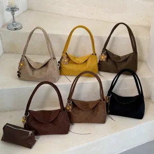 Classic suede shoulder bag with large capacity and elegant slouchy design for women everyday use.