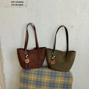Vintage woven suede shoulder bag for women, chic bucket bag with pendant design, stylish.