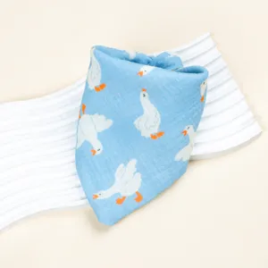 Close-up of blue baby bib with cute white duck print, soft cotton gauze fabric detail.