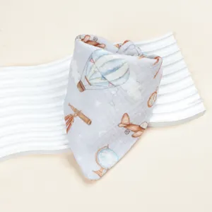 Infant cotton gauze bib detail showing retro hot air balloon print and soft fabric texture.
