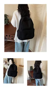 Casual black canvas backpack with large capacity, multi-pocket design for daily school use.