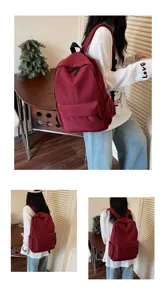 Casual red canvas backpack for women, minimalist daily school bag with spacious compartments.