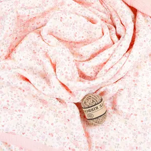 Pink floral cotton gauze baby blanket detail shot, showing soft breathable texture.