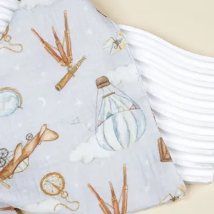 Soft cotton gauze baby bib with vintage adventure print, breathable double-layer muslin fabric.