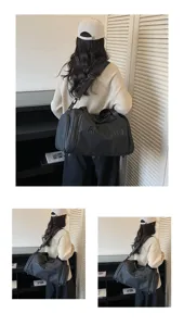 Detailed view of large black PU gym travel bag worn on shoulder, showing capacity and design.