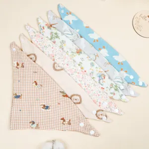 Detailed view of soft cotton gauze baby bandana bibs featuring cute animal and floral prints.