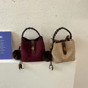 Borsa a secchiello vintage in camoscio in stile coreano con manico intrecciato e ponpon.
