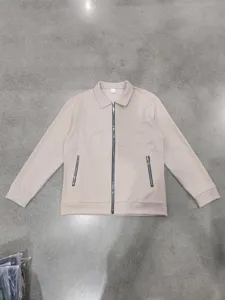 Detail shot of men's waffle knit full-zip casual jacket showing texture and zipper pockets.