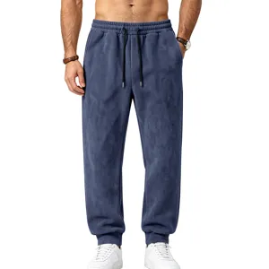 Men's suede sweatpants detail view, showing soft fabric texture, elastic drawstring waist and cuffed hem.