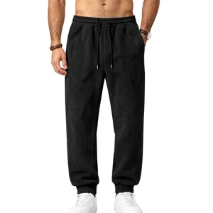 Detail view of men black suede fleece joggers, elastic drawstring waist and cuffed hems.