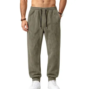 Detailed view of men's suede fleece joggers featuring an elastic drawstring waist and cuffed hems.