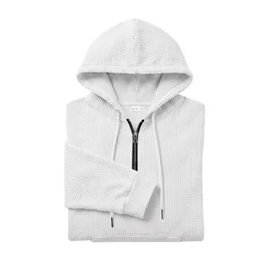 Men's white waffle knit quarter-zip hoodie detail showing texture, drawstring and collar.