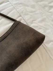 Detailed view of the vintage brown suede shoulder bag showcasing its premium texture and craftsmanship.